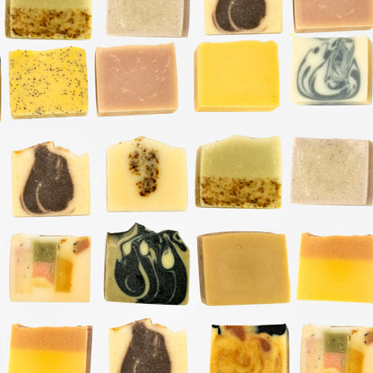 Assorted bars of soap with various textures and colors on a white background